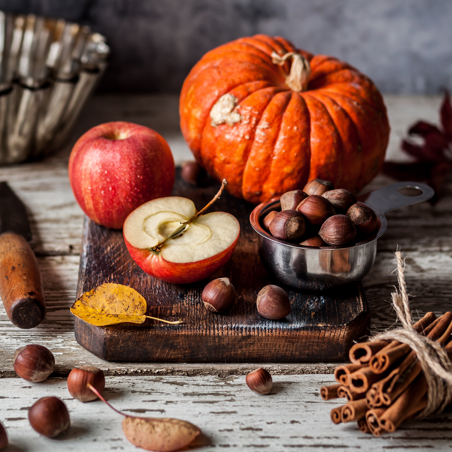 Apple Pumpkin Spice Candle with cinnamon sticks, apples, and a pumpkin centerpiece, perfect for autumn décor